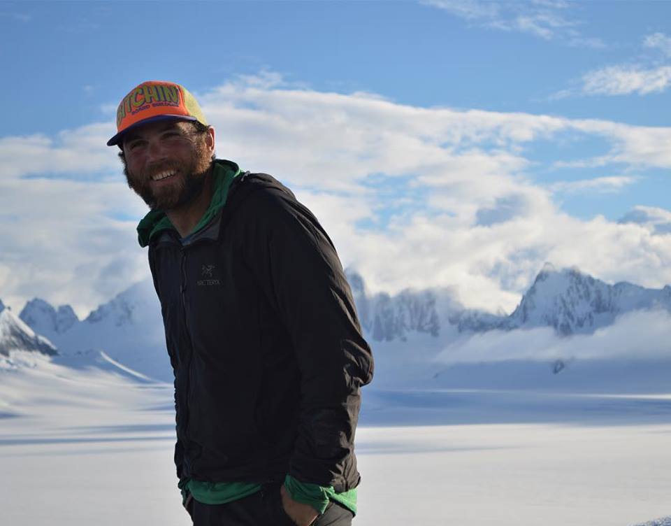 A man smiling in front of a beautiful scenic back drop of the Juneau Ice Field
